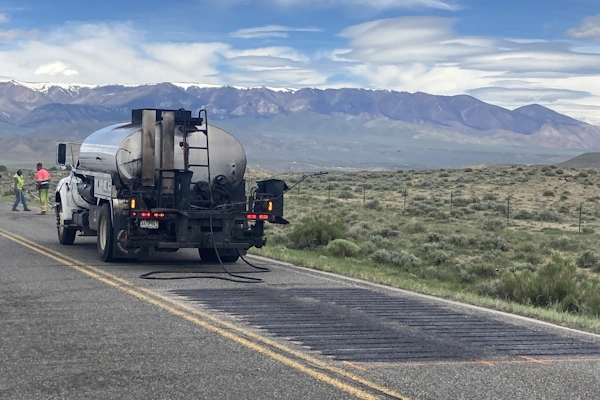 oil truck in front of sprayed rumble strips